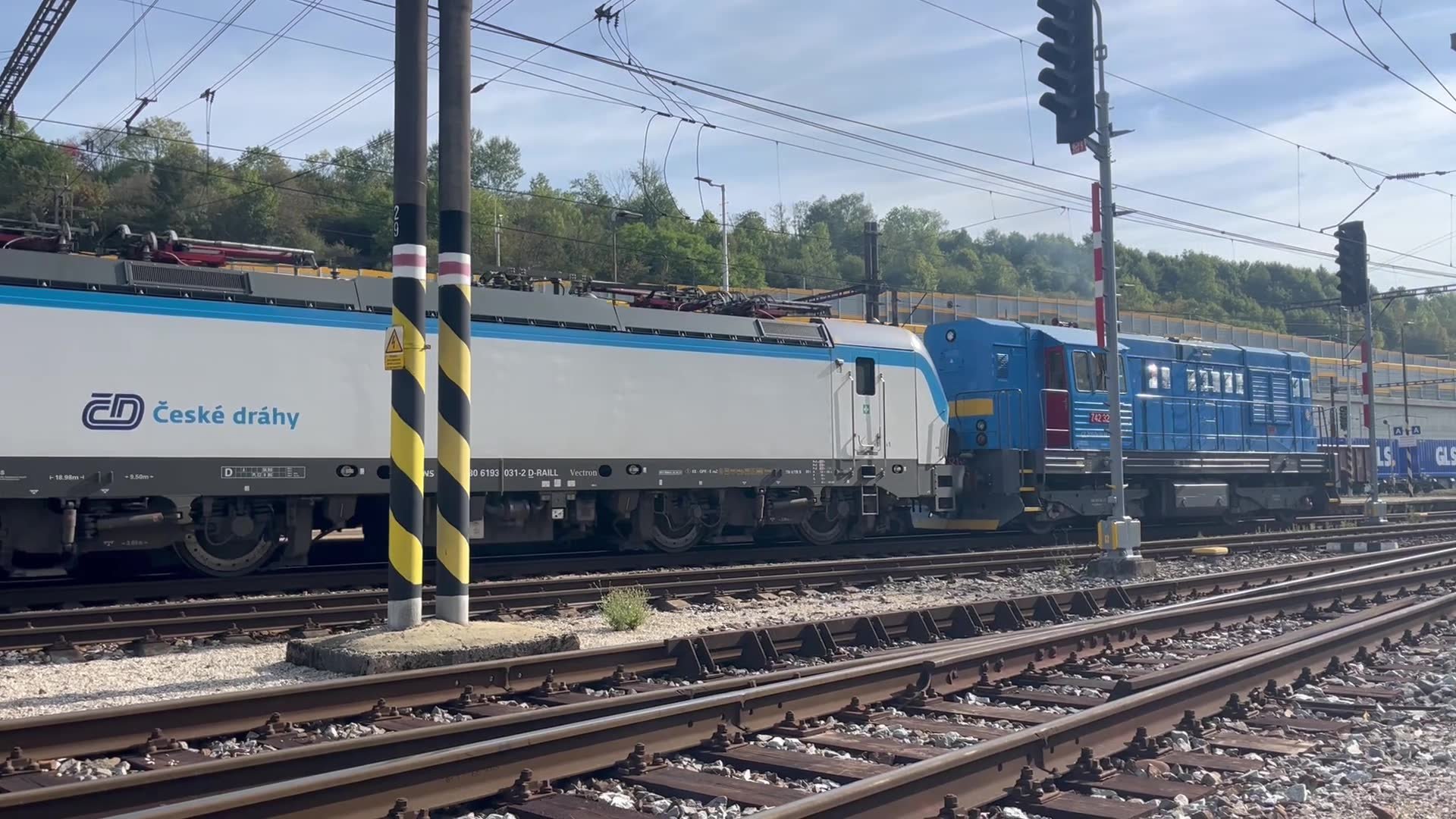 Shunting locomotive hauls a ČD service to Košice, departing Čadca
